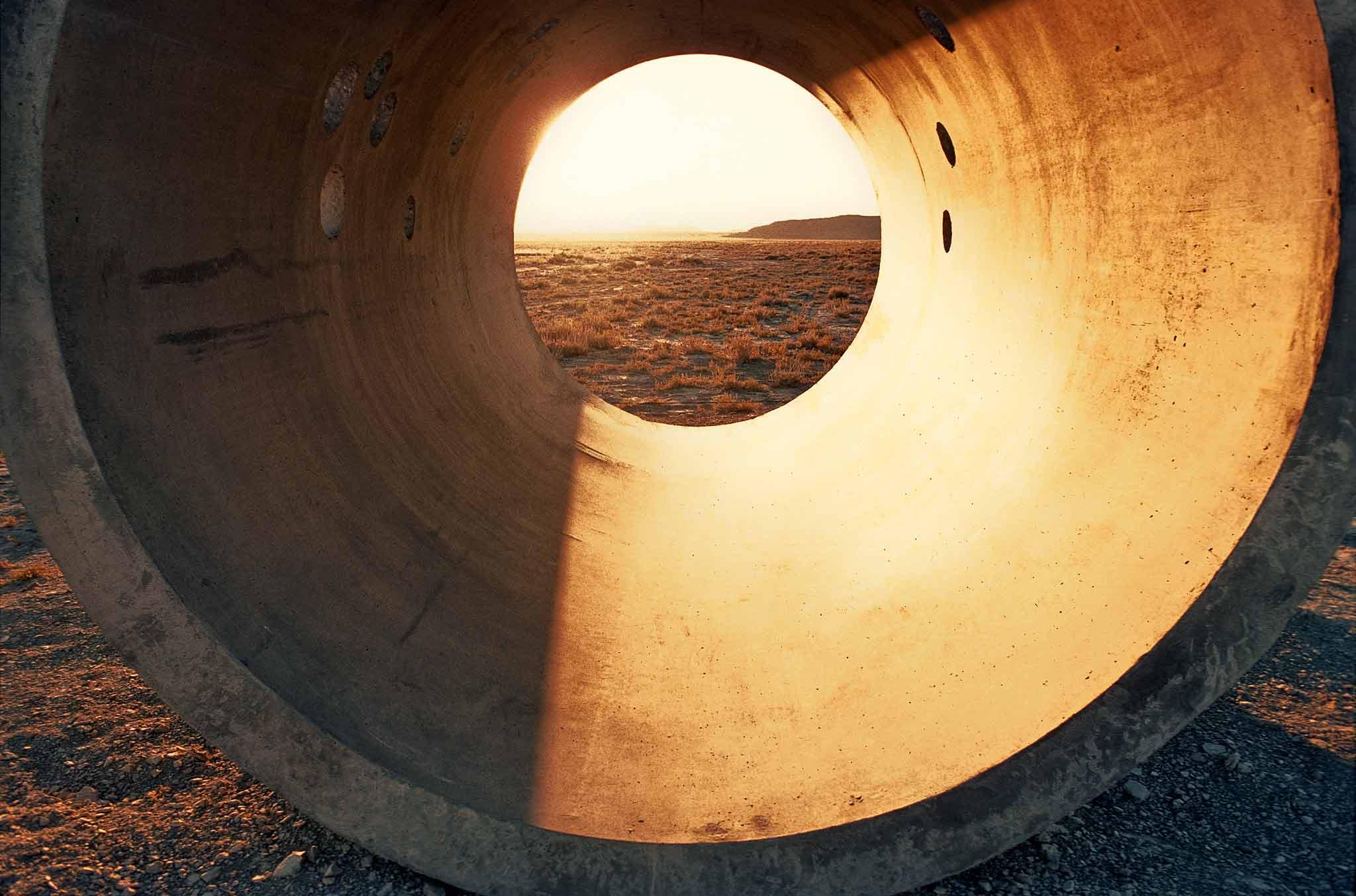 An interior of Sun Tunnels in the golden light of the setting sun.
