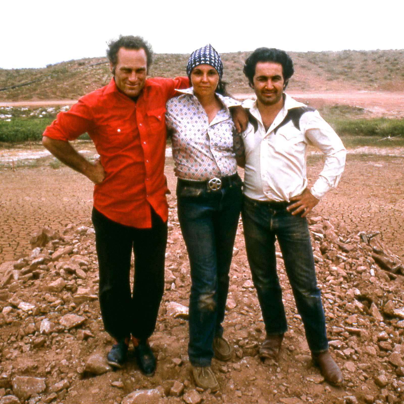 Three figures standing at the site of Amarillo Ramp in Texas